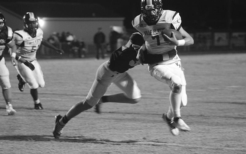 Bulldog quarterback Bastian Veillon (7) scrambles for extra yardage as he his pressured by a Church Point defender in Thursday night’s 58-20 loss to the Bears. (Gazette photo by Rhett Manuel)