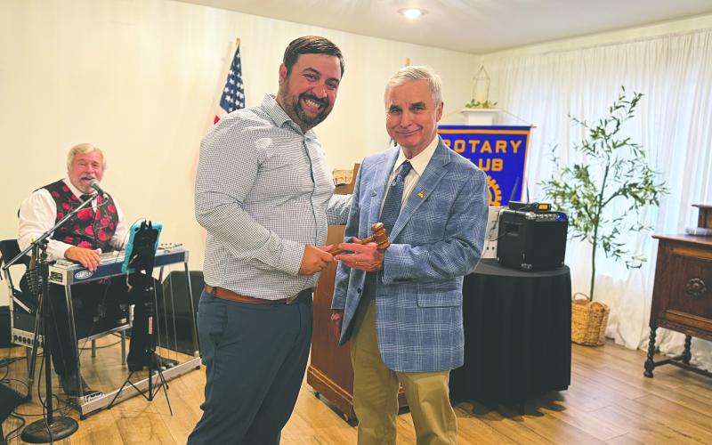 PASSING THE GAVEL - Outgoing president Beau Wilson (left) handed off the president’s meeting gavel to newly-installed president Dr. Kirk Soileau (right). (Gazette photos by Heather Bogard)