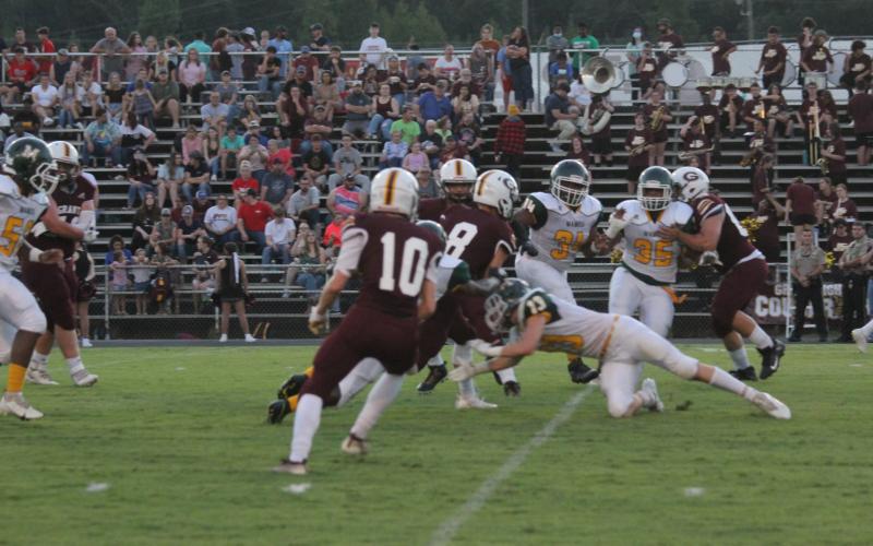 Caden Lejeune (13) lunges forward as he tries to make a tackle against a player from Grant in a Mamou game earlier the season. Lejeune and the rest of the Green Demons look to get their first non-forfeited win of the season at home tomorrow night against Port Barre. (Gazette photo by Tony Marks)