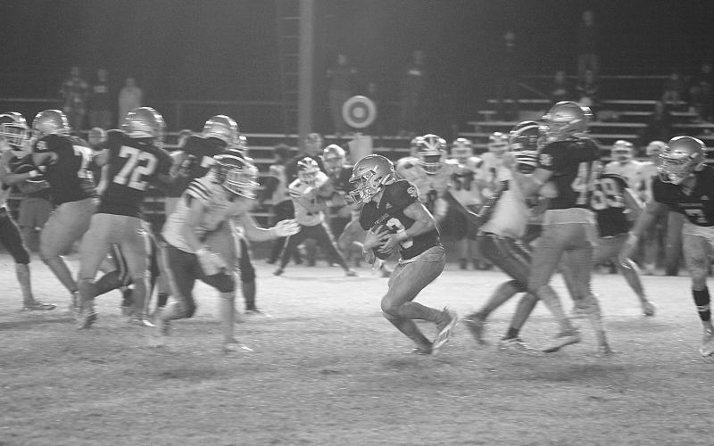 Jude Hebert (23) fights for additional yardage on a slick Soileau-Landry Field against the visiting Covenant Christian Lions in the first round of the Select Division IV playoffs. With the 32-8 win, Sacred Heart now travels to Ouachita Christian in the second round. (Gazette photo by Rhett Manuel)