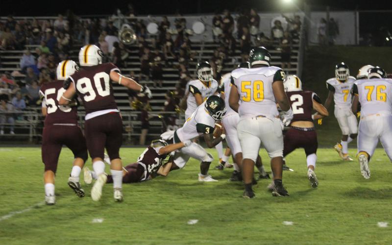 Mamou quarterback Jalon Bradley stays on his feet as he nets positive yardage on a drive that resulted in a touchdown in the Green Demons’ 36-30 road loss to Grant. (Gazette photo by Tony Marks)