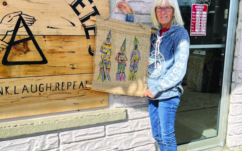 Kay Granger is shown with one of her many displays that hang inside the Greas E. Pete’s in Mamou. (Gazette photo by Heather Bogard)