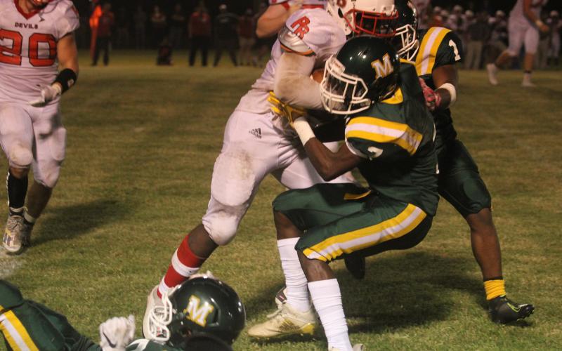 Jerez Edwards (7) makes a stop in Mamou’s game against Port Barre earlier this season. Edwards and the rest of the Green Demons dropped the regular season finale to Iota Friday. (Gazette photo by Tony Marks)