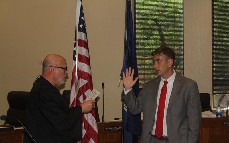 Justin Bo West (right) takes the oath of office as assistant district attorney from his second cousin, the honorable Judge Chuck West of the 13th Judicial District Court Division B. (Gazette photo by Tony Marks)