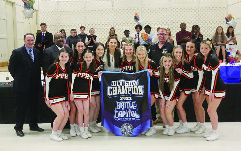 Pine Prairie High School cheerleaders (from left) Gracie Vidrine, Grace Holsomback, Carli Maricle, Addison Watts, Samara Lafleur, Alaina Boutte, Alexis Bordelon, Olivia Kidder, Skyla Fontenot, and Ava Kordish present a banner to captain Ainsley Dutton (center) at the Student of the Year Gala held Tuesday, May 3. Dutton, earlier that night, was recognized as the school district’s 12th grade student of the year.