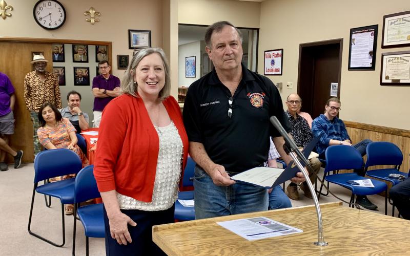 Community Liaison Jerri Ledoux (left) presents Ville Platte Firefighter Robert Perron (right) with a Congressional Commendation from U.S. Congressman Mike Johnson, who represents the state’s 4th district. Perron was honored for 50 years of service to the Ville Platte Fire Department. (Gazette photo by Nancy Duplechain)