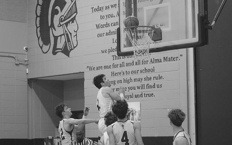 Cole Tate (11) goes up for a potential rebound in Sacred Heart’s home loss to Holy Savior Menard. (Gazette photo by Rhett Manuel)