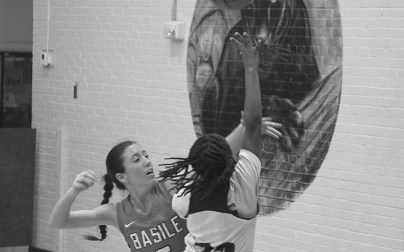 Vandryua Wilson (22) goes up for a rebound against a Basile Lady Bearcat in the opening game of the parish tournament. (Gazette photo by Rhett Manuel)