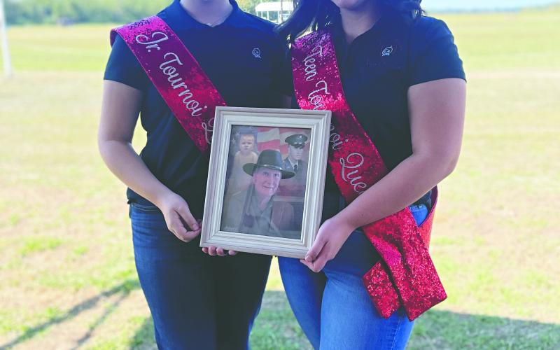 SISTER QUEENS HONOR GRANDFATHER WITH REIGN - Jr. Tournoi Queen Caydance Childers (left) and Teen Tournoi Queen Chloe Childers represented their late grandfather Michael Vidrine (shown in the photo they are holding), who was a former Tournoi rider, and dedicated their reigns to him. (Photo courtesy of Brook Childers)