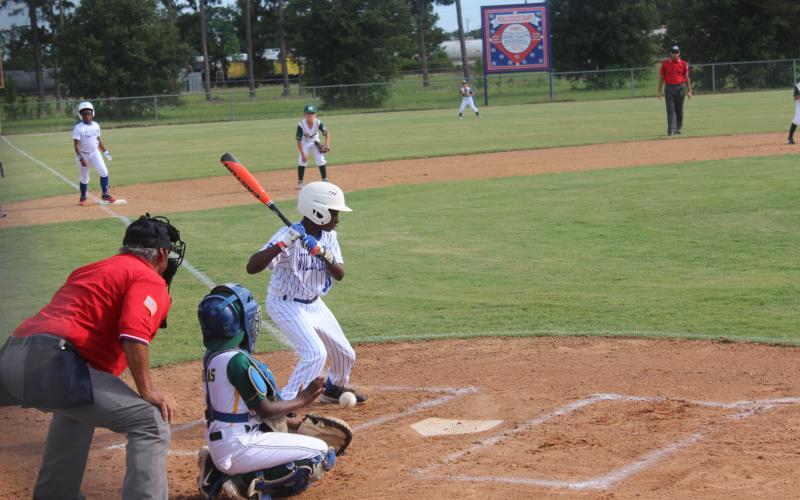With Deion Jones (2) standing 60 feet away on third base, I’Jai Lewis (30) watches a pitch cross home plate for a ball. Jones and Lewis are members of the Super 10 All-Stars from Ville Platte that took home the District 7 championship. (Gazette photo by Rhett Manuel)