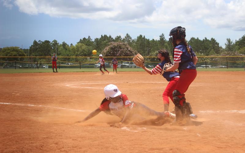 Ville Platte 10U All-Star Taylor Edwards slides into home plate after escaping a run down in her team’s 7-0 shutout win over West Mobile on Thursday at the All-American Youth Sports World Series in Gulfport, Miss. Ville Platte went 1-1 in pool play on Thursday and entered the double-elimination bracket portion of the tournament at the No. 5-seed. (Gazette photo by Rhett Manuel)