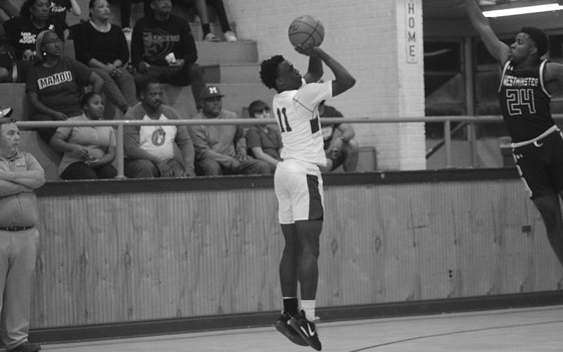 Zerick Weston (11) attempts a basket from beyond the arc in Mamou’s home court win against Westminster, 54-48. With the win, the Green Demons improved to 6-4 on the season. (Gazette photo by Rhett Manuel)