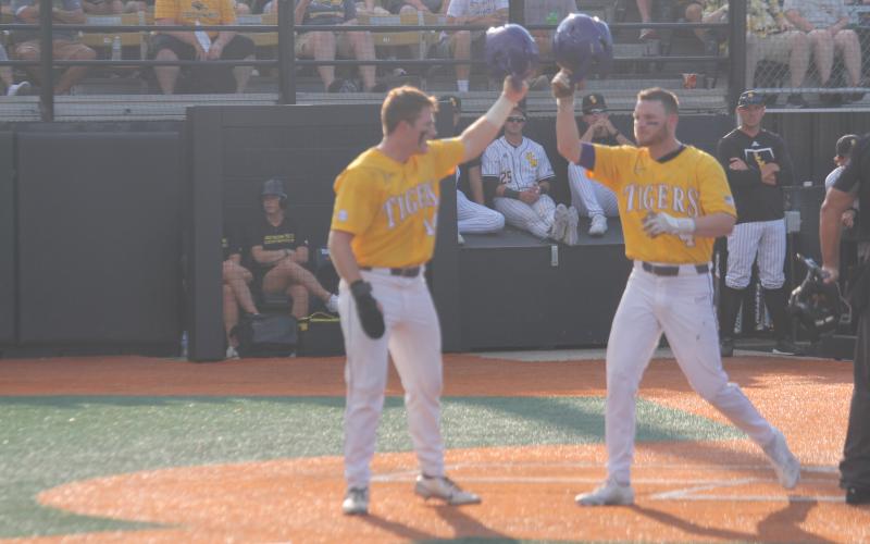 Cade Doughty  (4) gets a helmet salute from teammate Eric Berry (14) after both runners scored on Doughty’s two-run home run in the top of the first inning in LSU’s 8-4 loss to Southern Miss on Sunday, June 5. (Gazette photo by Tony Marks)