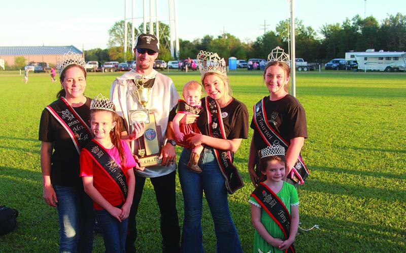 Alex Haller accepts his Tournoi championship trophy from members of the 2021 Tournoi Royalty.