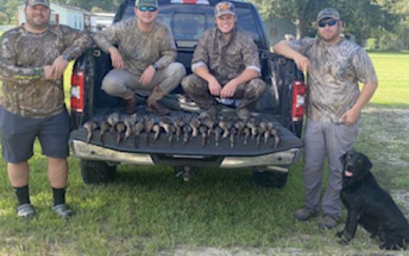 Pictured in no particular order are Sam Tuminaro, Seth Manuel, Steven Aguillard, and James Veillon with their dog, Callie, on the opening weekend of teal season this year. (Photo courtesy of Sam Tuminaro)