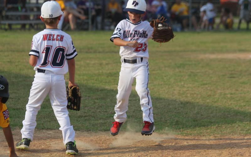 Shortstop Ty Fontenot (23) reacts as a play is made at first base in Ville Platte East’s opening game of the East Sub-District Tournament in Oakdale. Also pictured at first base in Levi Welch (10). (Gazette photo by Tony Marks)