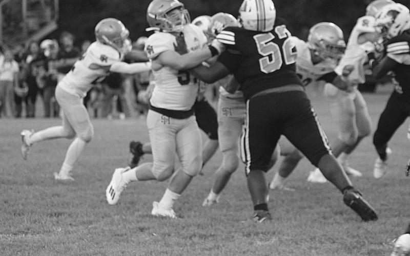 A Sacred Heart lineman makes a play against a Pine Prairie player in the jamboree. The Trojans take the field for the first time this season tomorrow night against Marksville at Soileau-Landry Field. (Gazette photo by Rhett Manuel)