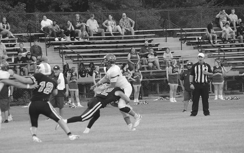 Pine Prairie defender Dylan Bordelon (22) collects a hit on the Merryville quarterback Remington Coody. (Gazette photo by Rhett Manuel)