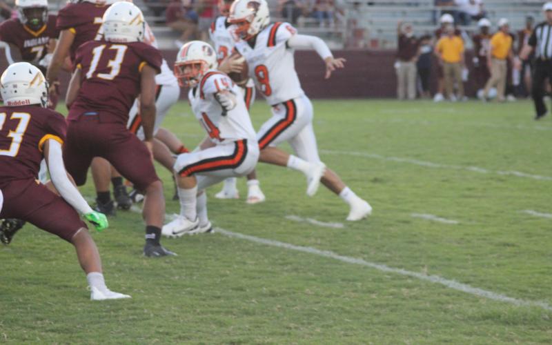 Chase Holsomback (14) looks to block an Elton defender in order to provide running room for quarterback Branson Fontenot. The Panther now head to Buckeye for a Week 3 matchup. (Gazette photo by Rhett Manuel)