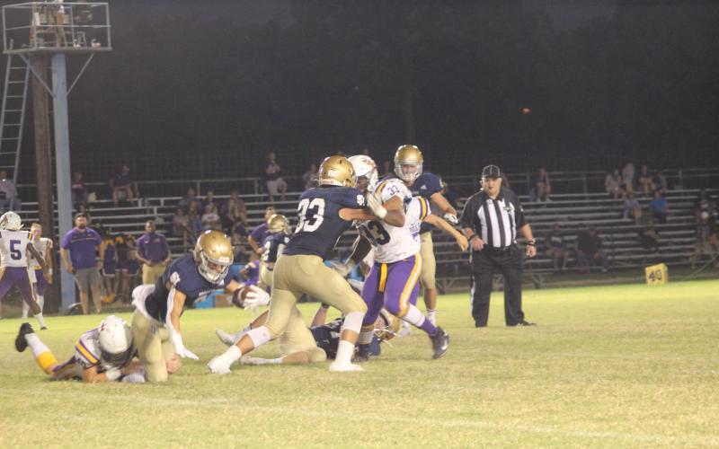 Sacred Heart’s Caleb Hood (3) dives forward for extra yardage after being tackled by a Marksville Tiger last week. Hood and the rest of the Trojans earned a win this week over parish rival Basile. (Gazette photo by Rhett Manuel)