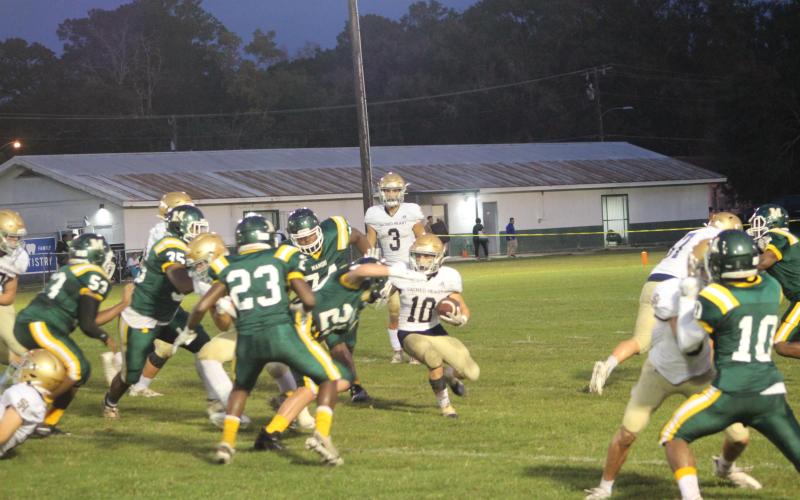 Blake Hebert (10) looks to find a seam against the Mamou defense earlier this season. Hebert and the rest of his Sacred Heart Trojans look to grab a win against their arch-rival Blue Jays in Eunice tomorrow night. (Gazette photo by Rhett Manuel)