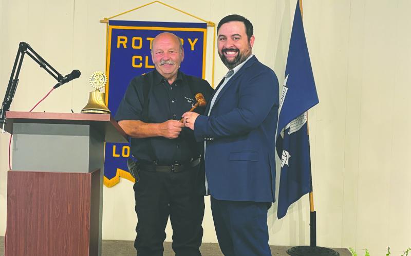 PASSING THE GAVEL - Outgoing president Bob Manuel (left) presented the president’s meeting gavel to newly-installed president Beau Wilson.
