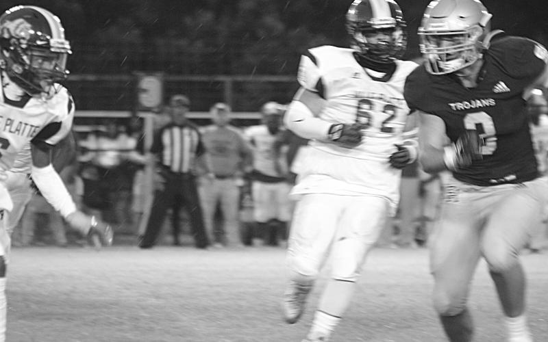 Briggs Ardoin (3) runs toward a Ville Platte High rusher as he looks to make a tackle for Sacred Heart in the Tee Cotton Bowl. Ardoin and the rest of the Trojans now take their show on the road for the second consecutive week. (Gazette photo by Rhett Manuel)