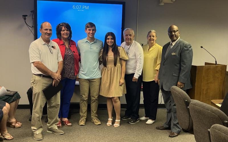 Pictured from left are Pine Prairie Assistant Principal Ted Fontenot, Secondary Supervisor Liz Chatelain, Grant Welch, Sophee Latour, school board members Wayne Dardeau and Monica Andrus, and Superintendent Darwan Lazard.