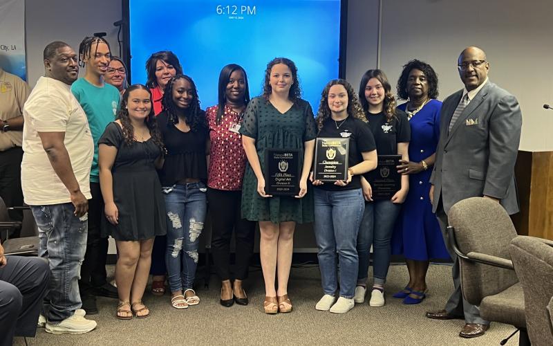 From left are: back row- Ville Platte Assistant Principal Dawn Bellard; middle row- Daylen Doucet and Chatelain; front row- board member Calvin Leday Jr., Hailey Bordelon, Destiny Lavigne, Ville Platte Principal Chenile Tezeno, Celeste Thille, Mallory Manuel, Caitlyn Ross, board member Wanda Skinner, and Superintendent Lazard. (Gazette photos by Tony Marks)