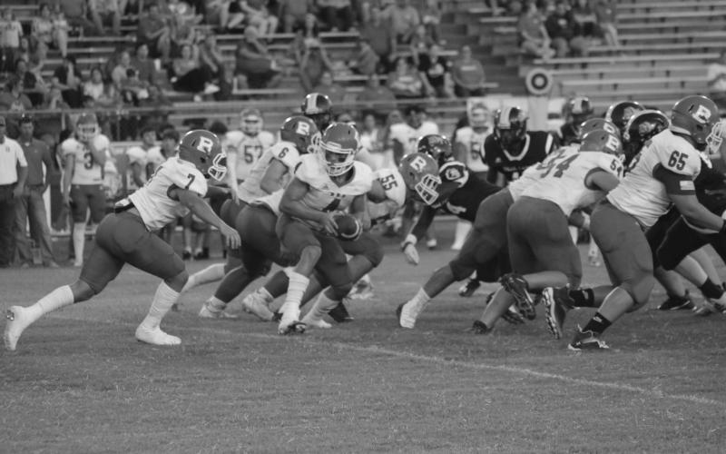 Basile quarterback Luc Johnson (4) hands the football off to Tucker Leblanc (7) last week against Ville Platte. This week, against Sacred Heart, the Bearcats fell 13-7. (Gazette photo by Rhett Manuel)