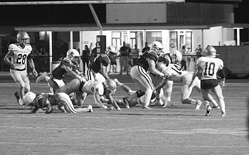 Ellis Shipp (14) makes a tackle against a St. Ed’s Blue Jay in the Sacred Heart Trojans’ 40-7 win on the road in Eunice. The Trojans now host Opelousas Catholic Friday for the district title. (Gazette photo by Rhett Manuel)