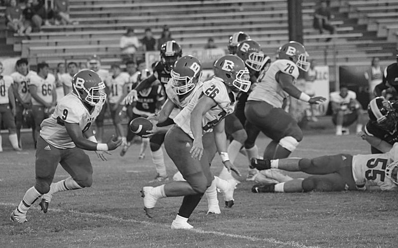 Horace Edwards (9) takes a handoff from Basile’s quarterback Luc Johnson (4) in Week 2’s contest at Ville Platte High. (Gazette photo by Rhett Manuel)