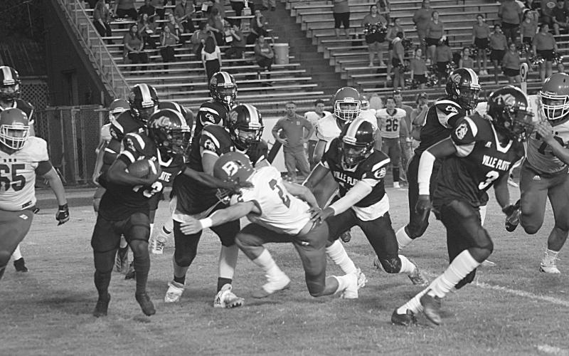 Ville Platte’s Montagon Dixon (13) avoids a tackle from Basile’s Jackson Courville (2) in the Bulldogs’ 35-20 home loss to the Bearcats last season. (Gazette photo by Rhett Manuel)