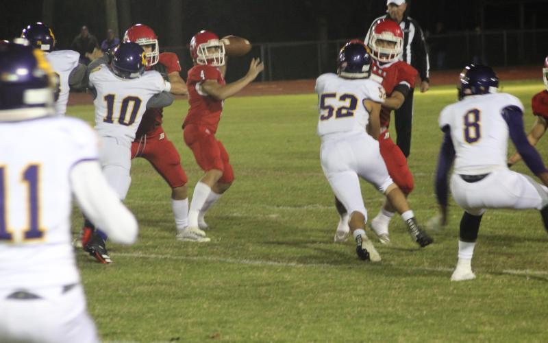 Basile quarterback Luc Johnson (4) drops back and tries to find an open receiver in the Bearcats’ regular season ending 20-13 over Oberlin Thursday night. (Gazette photo by Rhett Manuel)