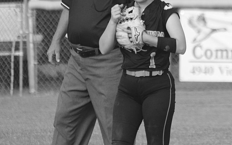 Victoria Briscoe (1) gives a fist bump to a Pine Prairie teammate after making a play at shortstop. (Gazette photo by Rhett Manuel)