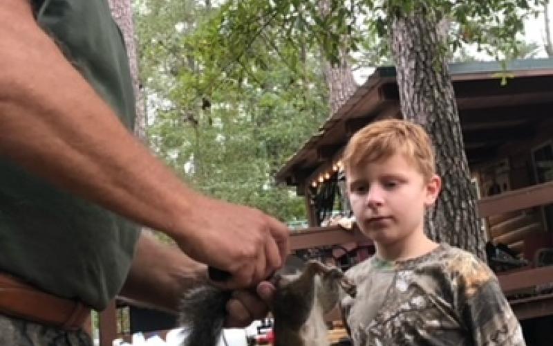 Pictured is Jesse Ludeau (left) showing his grandson, Chris, (right) how to clean a squirrel. (Photo courtesy of Christopher Ludeau)
