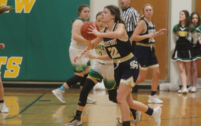 Sacred Heart’s Kali Shiver (22) looks to pass the basketball to a teammate in the Lady Trojans’ 65-23 loss at Plainview Tuesday night. Shiver was held to two points on the night. (LSN photo by Tony Marks)