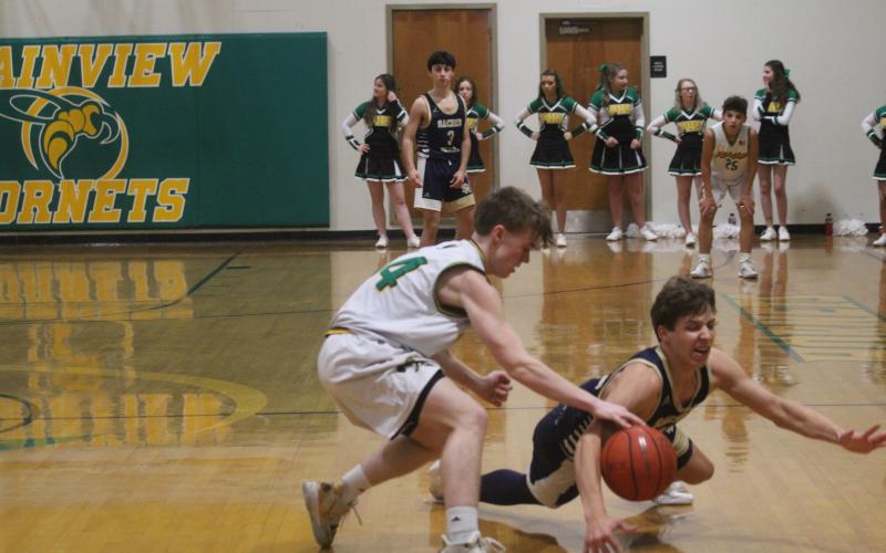 Austin Darbonne (21) goes after a loose basketball as his Sacred Heart Trojans take on the Hustlin Hornets of Plainview. Darbonne scored 11 of his 19 points in the fourth quarter as his team earned a 76-44 win. (LSN photo by Tony Marks)