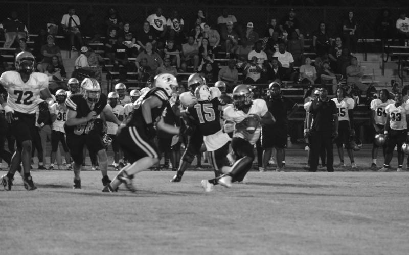 Caydon Descant (78) and Seth Ramsey (58) give chase and look to force a stop against Northwest in Pine Prairie’s 54-7 home loss Thursday night. (Gazette photo by Tony Marks)