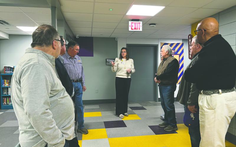 ERA Principal Alice LeJeune (center) leads members of the VIlle Platte Rotary Club on a tour of the Evangeline Reimagine Academy campus.