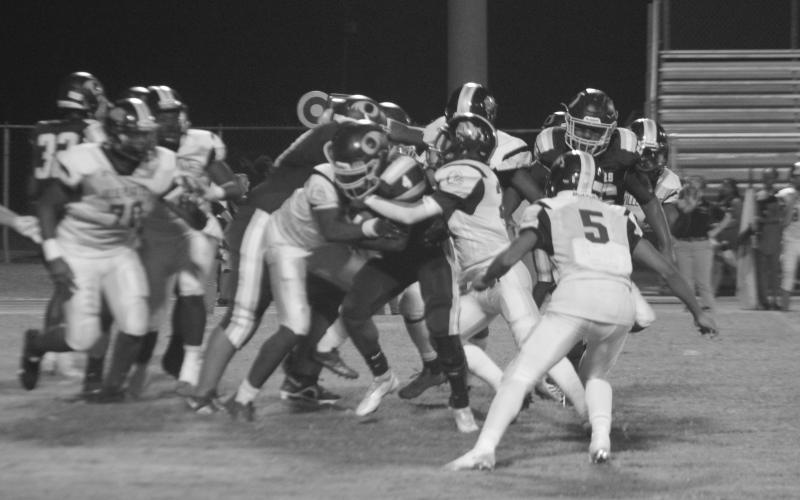 The Bulldog defense, led by Chance Fontenot (28), combines for a tackle of Charles Shird in Ville Platte’s 38-0 loss against Oakdale. (LSN photo by Tony Marks)