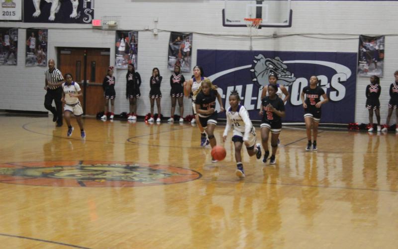 Vandryua Wilson (22) drives down the court for the Ville Platte High Lady Bulldogs in their playoff loss to Baker, 58-53, at home Thursday night. (Gazette photo by Rhett Manuel)