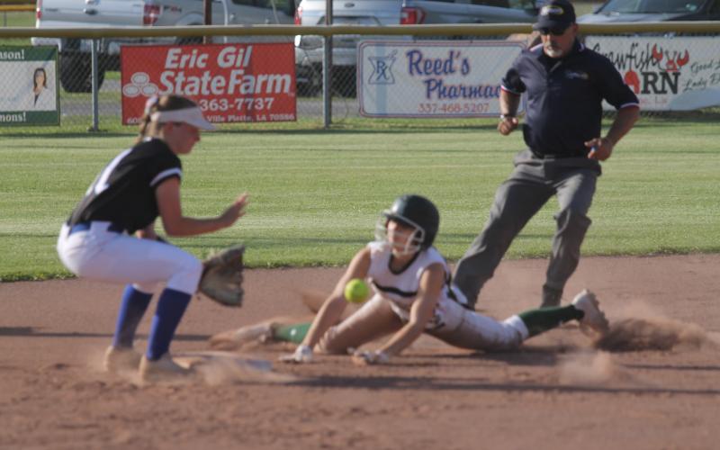 Kylie Rider (22) slides safely into the second base bag after leading off the game with a single. She later scored Mamou’s first run of the Lady Green Demons’ 8-3 win over Erath in the Class 3A playoffs. The team now plays Buckeye today at 6 p.m. (Gazette photo by Tony Marks)
