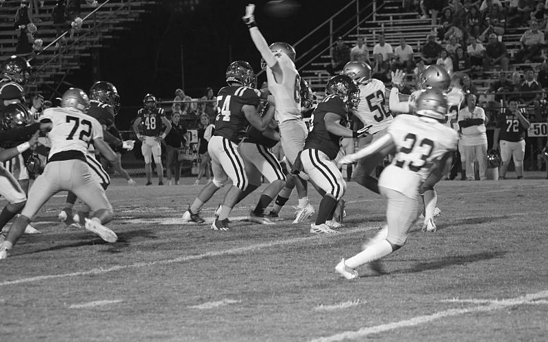 A Sacred Heart defender leaps up to deflect a pass in the Trojans win against St. Edmund last week. (Gazette photo by Rhett Manuel)