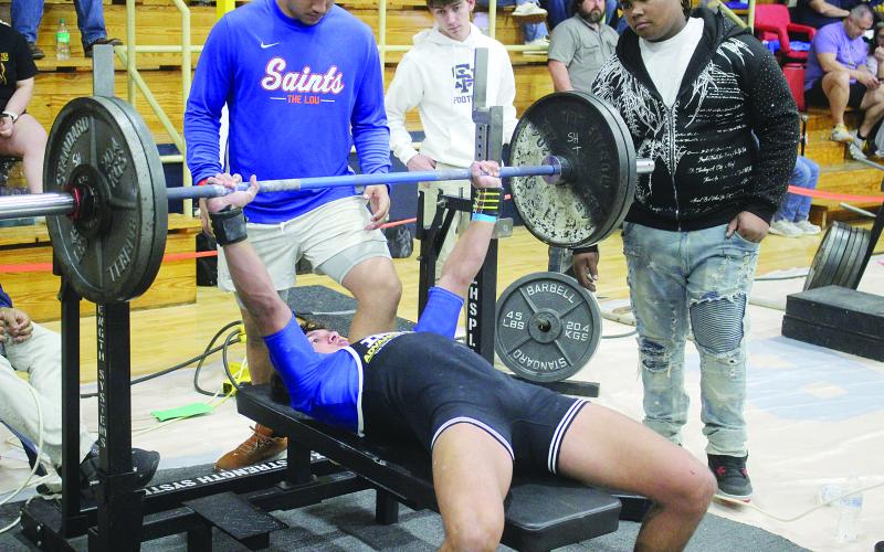 Gavin Patin, of Sacred Heart, is pictured as he attempts a bench press during the invitational held Saturday, January 10. He competed in the 148 weight class with a total of 1,025 pounds. (Gazette photo by Tony Marks)