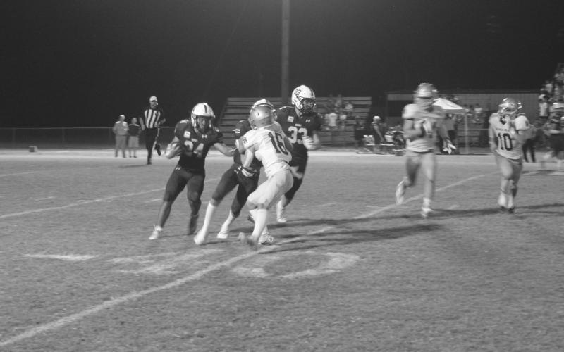 Boyce Schexnider (16) tries to make a defensive stop in Sacred Heart’s win at Menard. The Trojans now head up Hwy 165 to Columbia for a battle against Caldwell Parish Thursday night. (Gazette photo by Tony Marks)