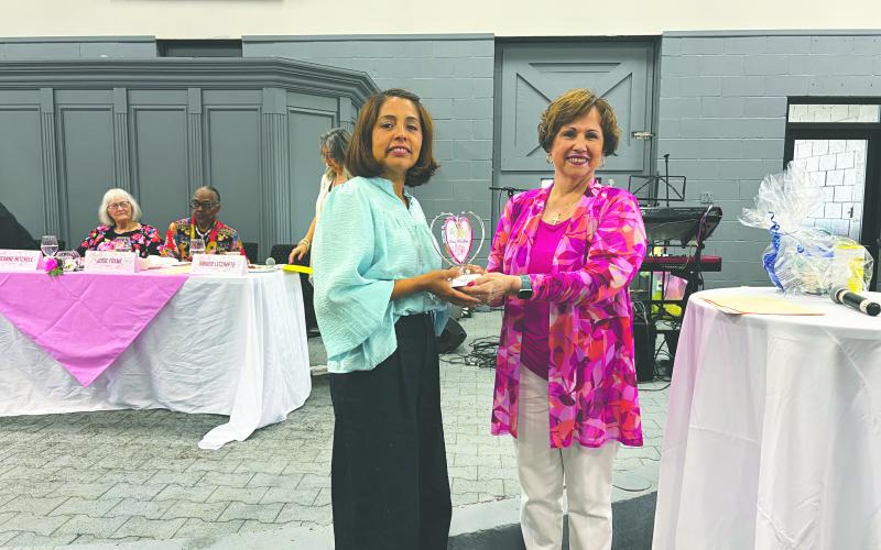 Sarahi Sawtelle (left) was the recipient of the Women With Heart Award for Evangeline Parish. In the above photo, she is presented her award by Sonia Ardoin (right). (Gazette photo by Heather Bogard)
