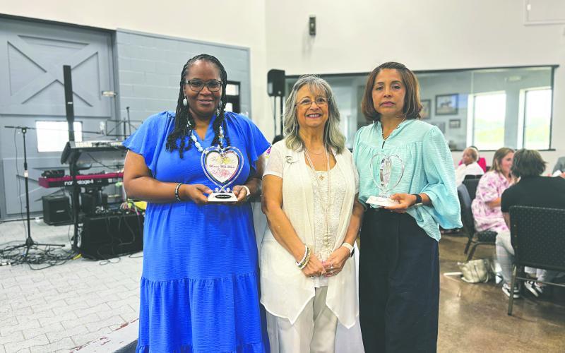 Women With Heart honorees Madelyn Rosette (left) and Sarahi Sawtelle (right) pose with St. Landry-Evangeline United Way Executive Director Ginger LeCompte shortly after the award presentations. (Gazette photo by Heather Bogard)