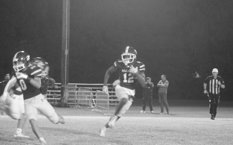 Mamou’s Ashton Johnson (12) looks for positive yards in the Green Demons’ home loss to Iota. (Gazette photo by Tony Marks)
