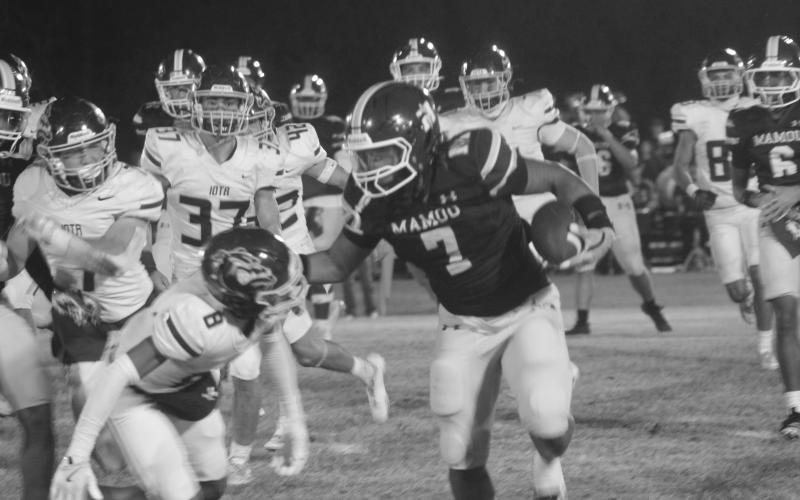 Keontez Campbell (7) looks to avoid a tackle from an Iota defender as Mamou lost 48-0 on Halloween night. The Green Demons (3-6) end the regular season tomorrow night at Pine Prairie against the Panthers. (Gazette photo by Tony Marks)